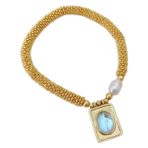Classic gold beaded bracelet with freshwater pearl and blue gemstone heart cross pendant