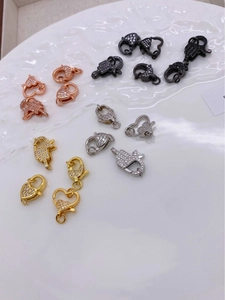 Macro shot of 18K gold plated lobster clasps with zircon heart shapes for DIY necklaces