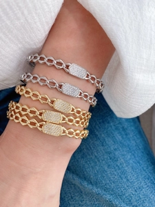 Detailed view of fashionable chain bracelets with sparkling rectangular diamond blocks