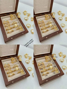 Detail view of 18K gold plated marine rings with starfish and crab designs in a box