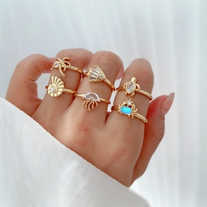 Set of 6 gold ocean theme rings featuring turtle, crab, and starfish with pearls