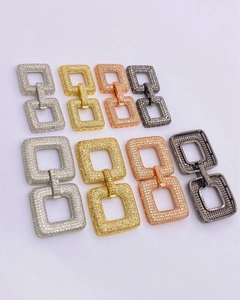 Detailed view of four interlocking rectangle clasps in silver, gold, rose gold, and black