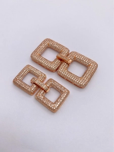 Macro detail of rose gold jewelry clasp with hand-set cubic zirconia pave stones