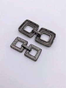 Detailed macro view of square gunmetal clasps with micro-pave white cubic zirconia