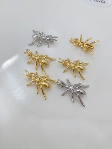 Vue macro de pendentifs d'araignées dorés et argentés pour la création de bijoux