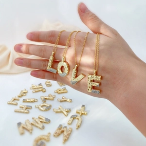 Gold 18k plated alphabet initial pendant with zircon stones and lava texture finish