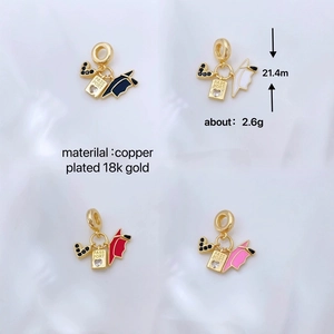 Detail of graduation charms with 18K gold plating, enamel caps and passport tags