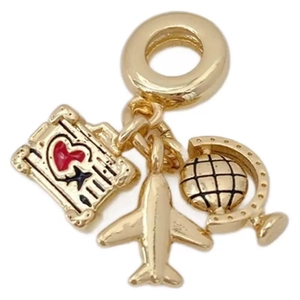 Golden travel charm necklace with airplane, globe, and suitcase pendants on white background