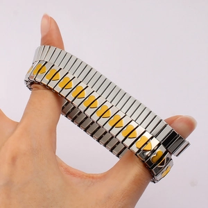Detail of stretchable stainless steel bracelet with silver links and yellow hearts