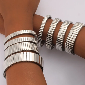 Polished silver stainless steel expansion bracelets in four widths on wrist