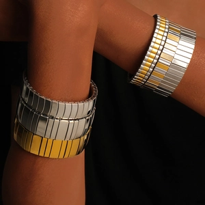 Detailed view of elastic stainless steel watch-band style bracelets in gold and silver