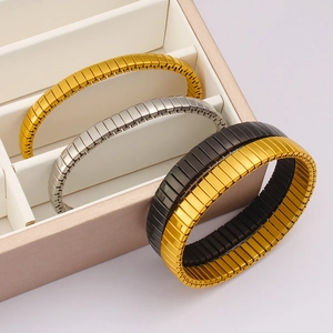 Polished stainless steel stretch bracelets in gold, silver and black displayed in a box