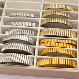 Close-up of elastic stainless steel watch band bracelets in gold, silver, and dual-tone finish