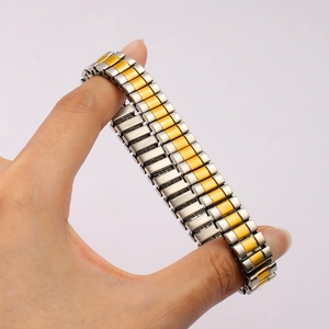 Detail of two-tone stretch bracelet band showing high flexibility on a person's wrist