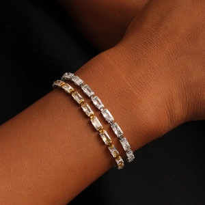 Detail of adjustable 18K gold and silver tennis bracelets with square zircon stones