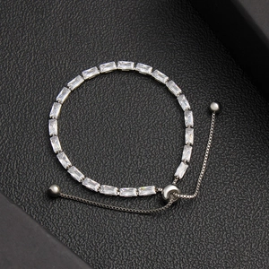 Detailed macro view of silver adjustable tennis bracelet with square-cut cubic zirconia