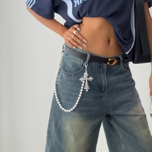 Detail of hip-hop waist chain with white faux pearls and baroque silver cross pendant