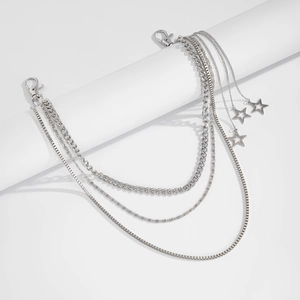 Macro view of multi-layered silver metal pants chains with star charms and lobster clasps