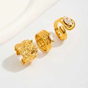 Detailed macro view of a 3-piece gold lava texture ring set with marquise cut crystals