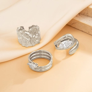Detailed view of silver lava texture ring and wrap-around ring with marquise zirconia