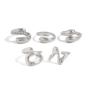 Detailed set of five silver liquid metal rings featuring teardrop and wavy wave designs