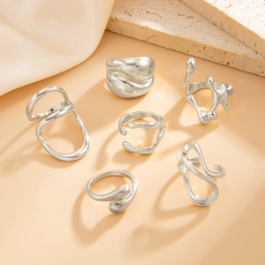 Set of six irregular liquid metal rings with lava texture and polished silver finish