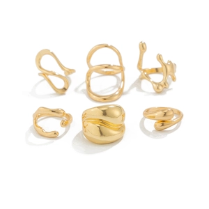Detail view of 6-piece gold liquid lava rings with irregular organic shapes and polished finish
