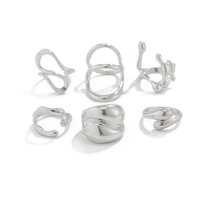 Detailed macro view of a 6-piece silver liquid metal style irregular ring set
