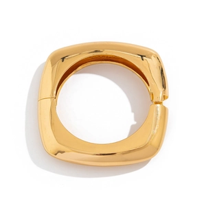 Close-up of polished gold square metal bracelet with minimalist geometric design