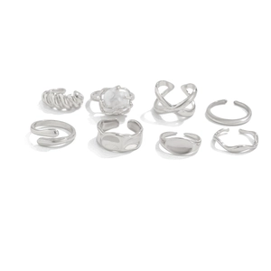 Detailed set of 8 silver stacking rings featuring wavy textures and pearl accents
