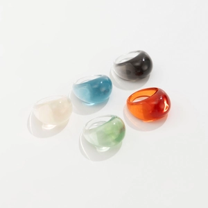 Detailed view of five colorful translucent resin bubble rings in a minimalist chunky design