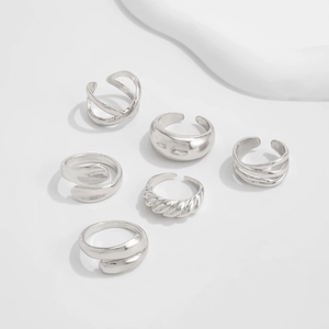 Detailed close-up of a 6-piece silver ring set with minimalist and textured designs