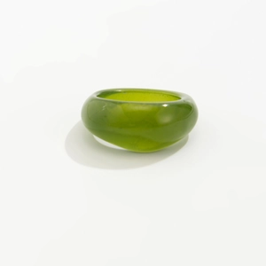 Close-up of thick translucent green resin ring with a polished minimalist round finish