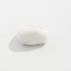 Macro shot of minimalist white resin ring with glossy polished finish and smooth surface