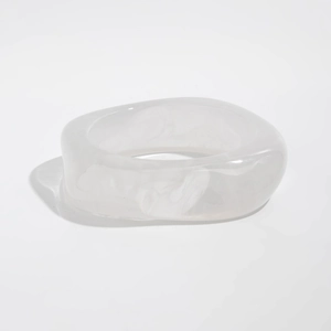 Macro shot of translucent white resin bangle with gold foil and marble pattern