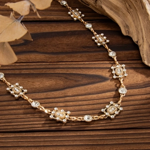 Vintage geometric square rhinestone waist chain in gold finish on wooden background