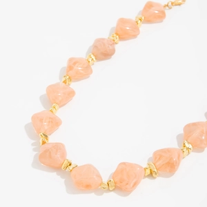 Detail of pink marble resin beads and gold metal spacers on this stylish choker necklace