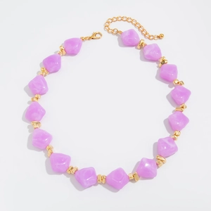 Detailed view of light purple resin beads with gold metal spacers and adjustable lobster clasp