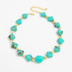 Detail of irregular turquoise resin beads and gold metal spacers on adjustable necklace