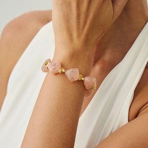 Close-up of pink marble resin beads and gold accents on a women's beaded choker necklace