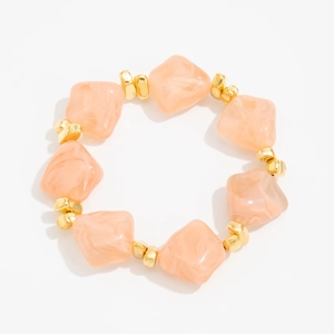 Detail of pink resin beaded choker featuring irregular marble texture and gold metal spacers