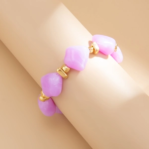 Detailed close-up of irregular light purple resin beads with gold spacer accents on choker