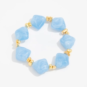 Detail of irregular blue resin beads with gold spacer accents on a beaded choker