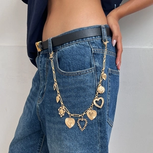 Gold layered heart and sunflower charm pant chain with secure lobster clasps on denim