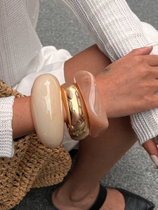 Three-piece chunky bracelet set with cream resin, gold metal, and amber acrylic bangles