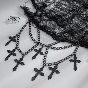 Macro shot of Gothic black multi-layer body chain featuring detailed cross pendants