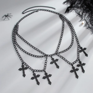Macro view of multi-layered black metal gothic waist chain with ornate cross pendants