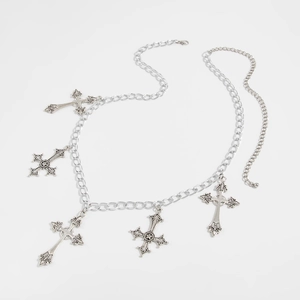 Close-up of gothic cross charms on vintage silver metal bikini body chain jewelry
