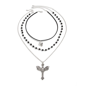 Close-up of gothic triple-layer necklace with cross, skull pendant and black beads