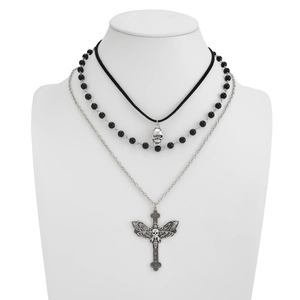 Detail of triple-layer gothic necklace with skull, beads, and moth cross pendant